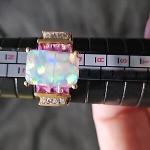 Huge opal setting, pink ice, and cubic zirconia on a gold band
